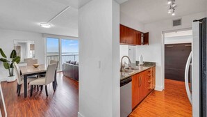 A modern apartment with a dining area, kitchen, and balcony with a view. - The Club 1601 · Ocean View Amazing Unit Brickell (Miami)