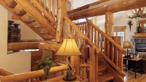 A wooden staircase with a lamp on the landing. - Amazing Mountain Home in Blue River-7 minutes from Breckenridge! (Blue River)