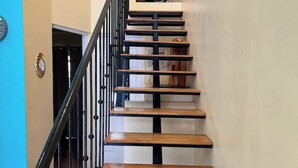 Un escalier avec des marches en bois et des rampes noires.