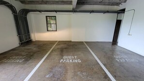 A parking area with 'GUEST PARKING' markings on the floor. - Lovely 2 bdrm Condo in Pacifico (Coco)