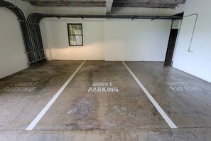 A parking area with 'GUEST PARKING' markings on the floor. - Lovely 2 bdrm Condo in Pacifico (Coco)