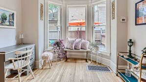 A cozy reading nook with a bench, a small table, and a chair. - Cozy Victorian | King Bed, Private Yard, Walk to SoBo Restaurants (Denver)
