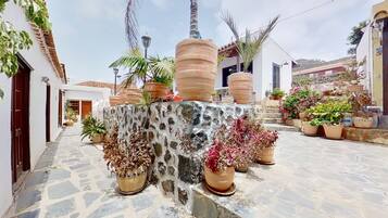 Surrounded by lush greenery, this tranquil courtyard offers a serene escape.