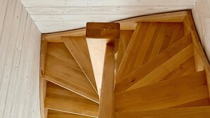 A wooden spiral staircase with a central column and wooden walls. - Gorgeous home in Sarbinowo with WiFi (Sarbinowo)
