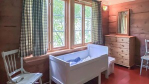 A room with a white bathtub, a wooden dresser, a chair, and a window with curtains. - Stunning home in Tonstad with WiFi (Tonstad)