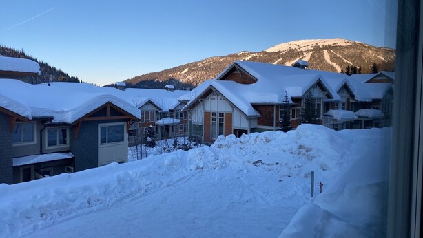A snow-covered residential area with houses and a mountain in the background. - Beautiful Echo Landing Retreat, Sleeps 8, 3 Bdrm, Private Hot Tub, Ski In/Out  (Sun Peaks)