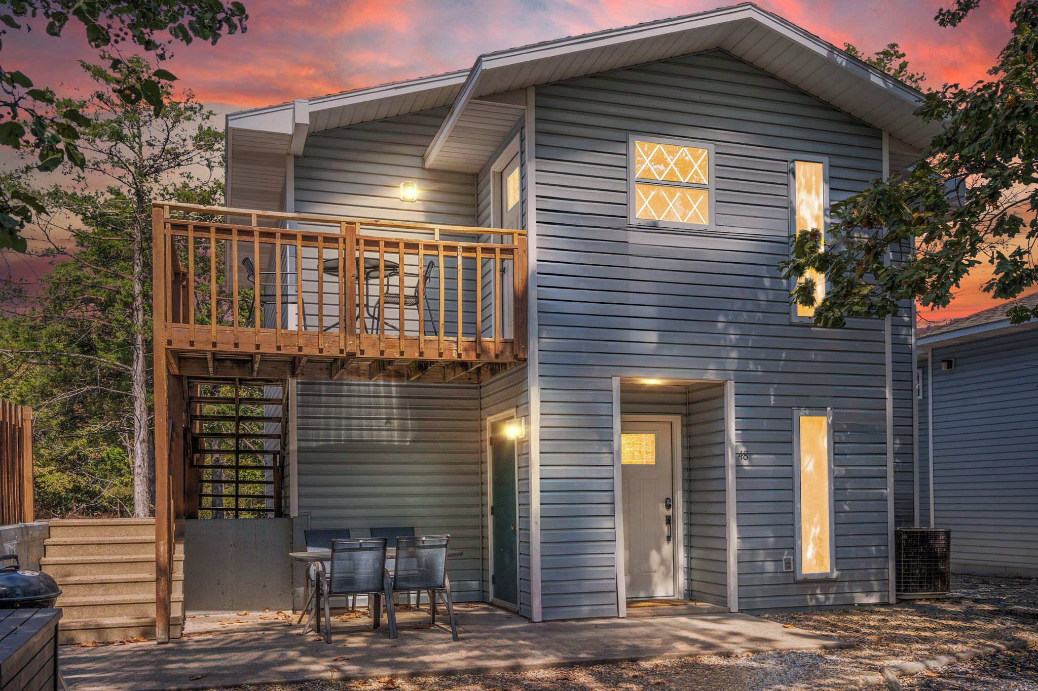 A two-story house with a balcony, a covered patio, and a garage.