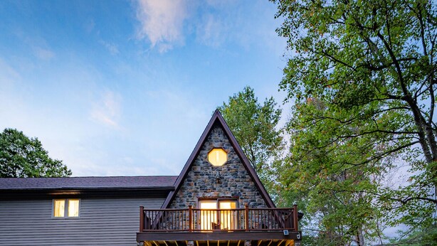 A stone house with a balcony, a front porch, and a pathway leading to the entrance. - Horseshoe Acres - Home theater, spa room, hot tub (Oak Hill)