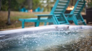 A hot tub with a view of outdoor seating and trees in the background. - Horseshoe Acres - Home theater, spa room, hot tub (Oak Hill)
