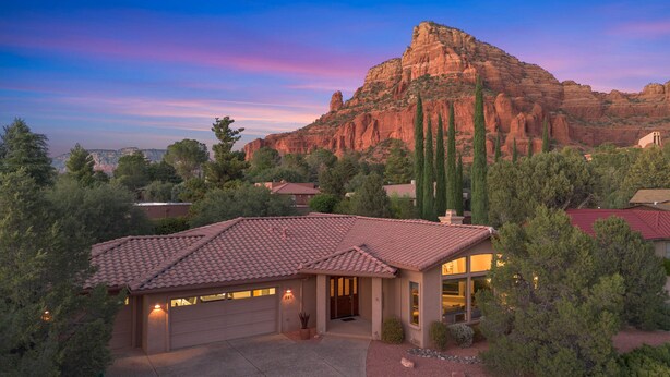 A house with a red-tiled roof, a garage, and a driveway. - Sedona Among the Rocks: Luxurious 3BR home with stunning Red Rock views in the Chapel Area. (Sedona)