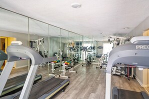 A gym with treadmills, weight machines, and free weights. - Pet Friendly (no pet fees) | Ground Level | Pool | Fitness Center | Tennis/Pickleball | Playground (St. Simons Island)