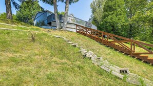 A wooden staircase leading up to a building with a deck. - Waterfront Cottage w/ Dock & Views in Six Lakes! (Six Lakes)