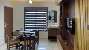 A modern kitchen with a built-in oven, a sink, and a wooden cabinet. - Town Inn Apartments (Perintalmanna)