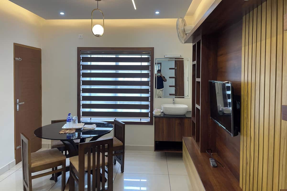 A modern kitchen with a built-in oven, a sink, and a wooden cabinet.