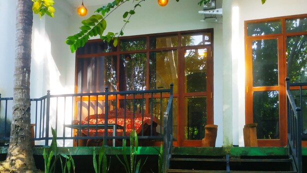A house with a porch, a staircase, and a large window.