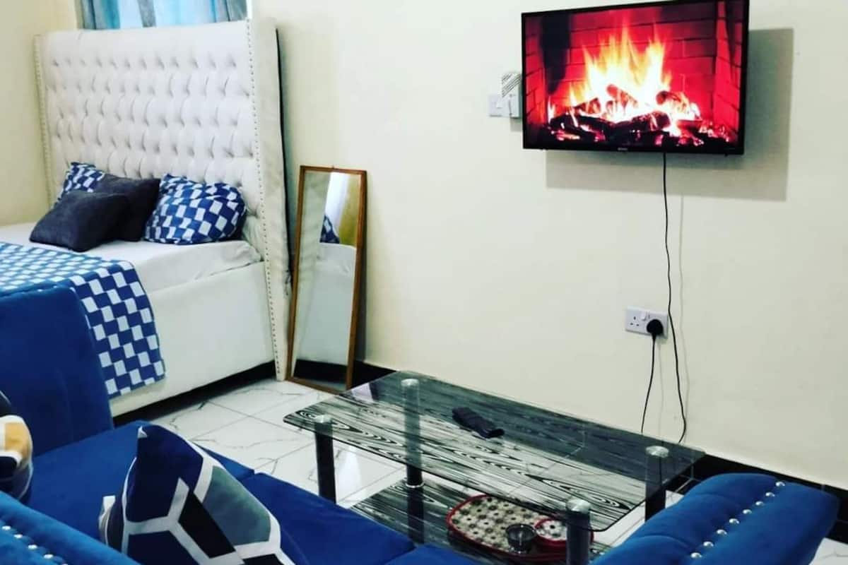 Deluxe Studio Suite, Balcony, City View | Living area | 24-inch Smart TV with digital channels