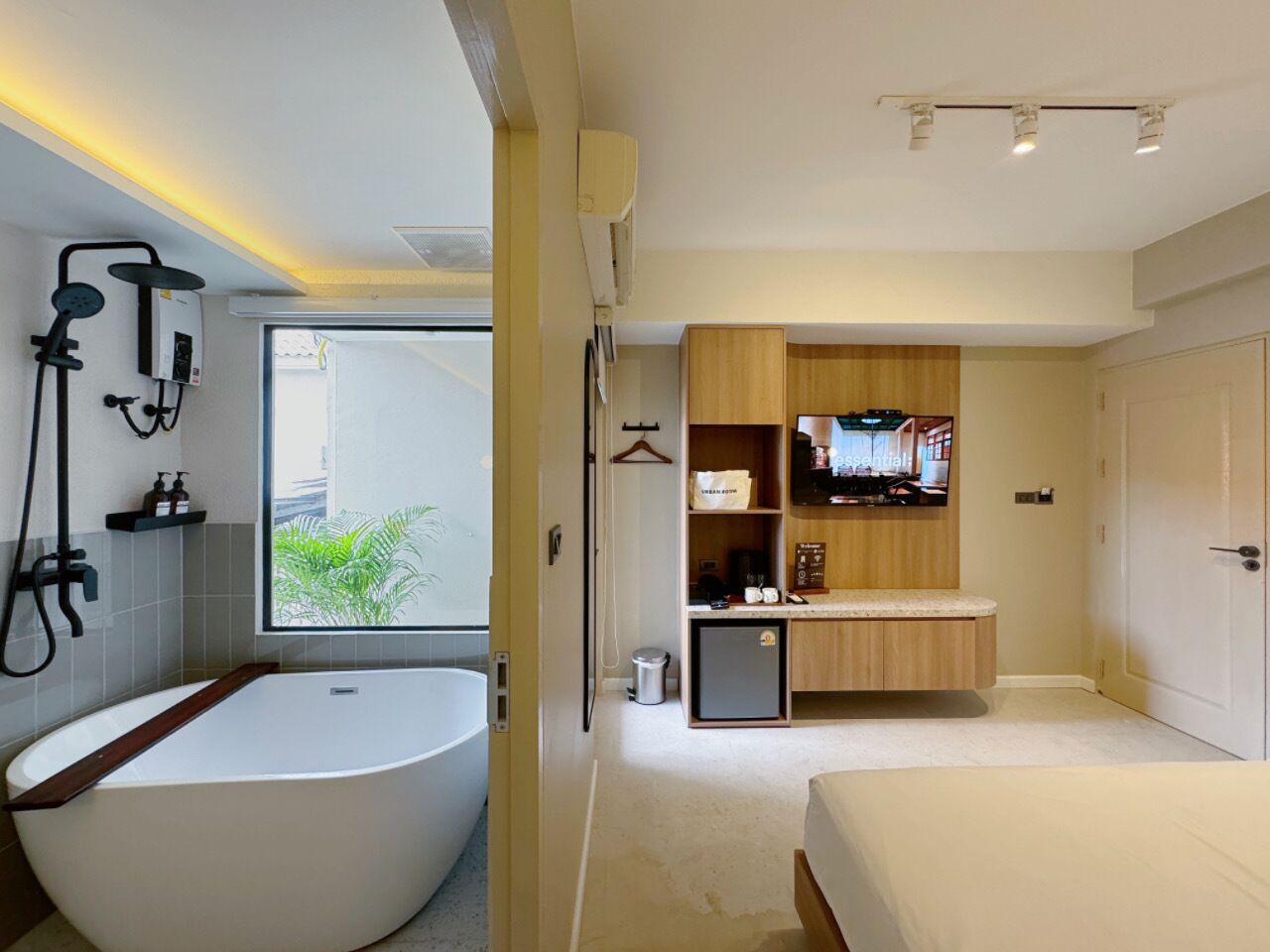 A modern bathroom with a large bathtub, a shower area, and a vanity with a mirror.