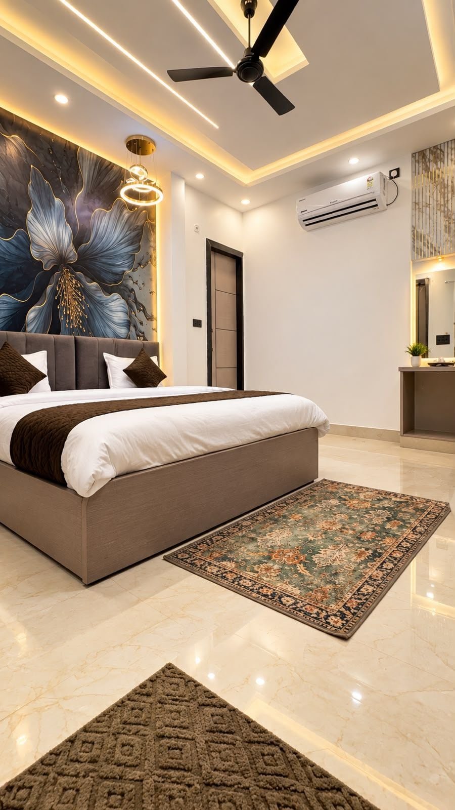 A modern bedroom with a large bed, a ceiling fan, recessed lighting, and a decorative wall mural.