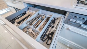 A kitchen drawer with utensils and a coffee machine. - Guest House Terrace (Miyakojima)