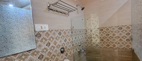 A bathroom with a sink, toilet, and shower.