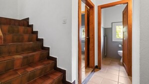 A staircase leading to a bathroom with a toilet and sink. - Pretty chalet-style studio (Euseigne)