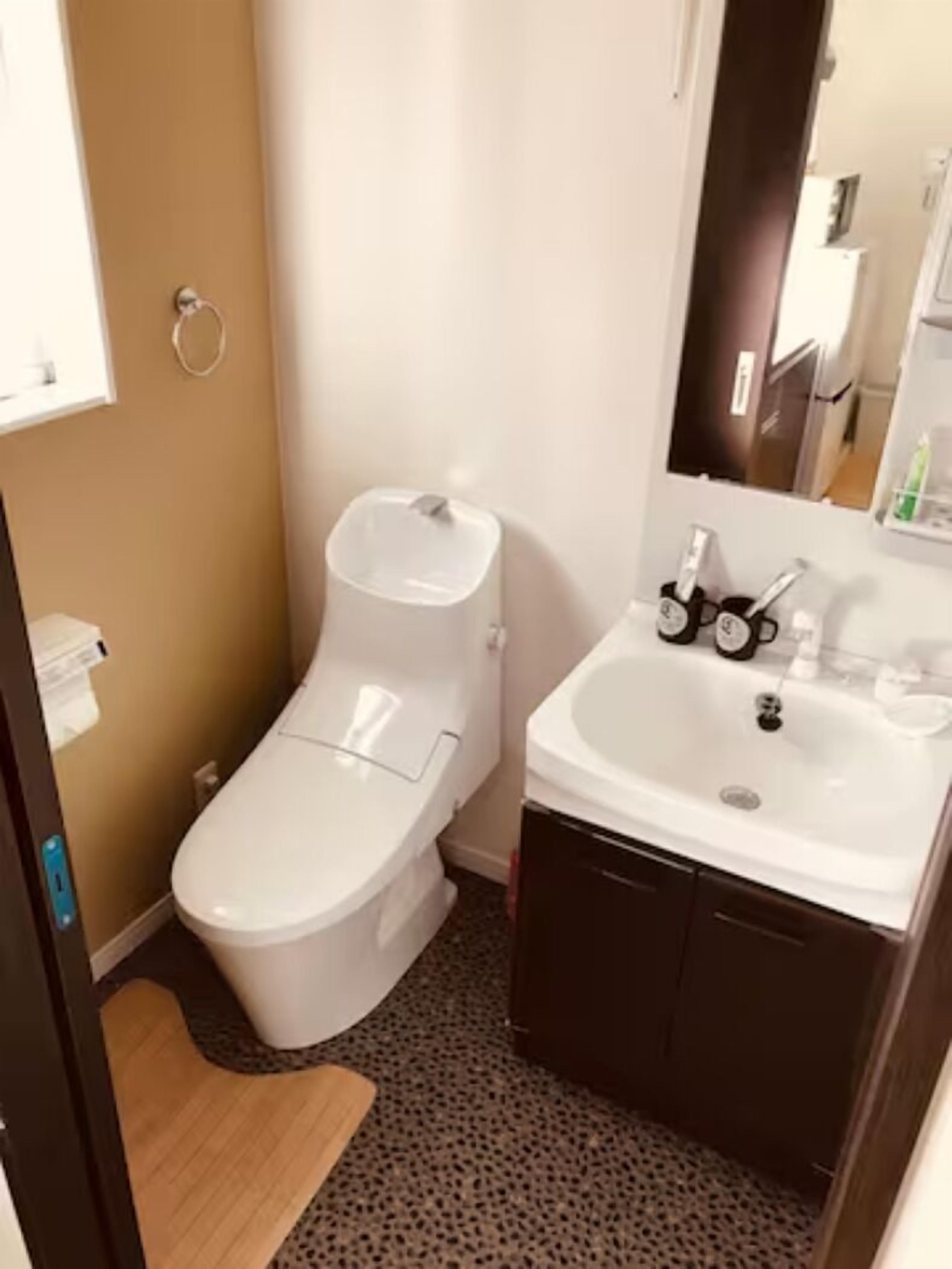Um banheiro pequeno com vaso sanitário, pia e espelho.