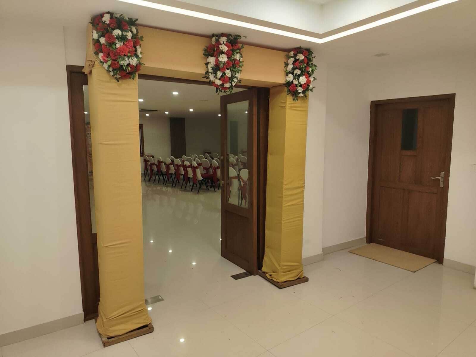 A room with a door, a mirror, and a tiled floor.
