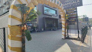 A hotel entrance with a sign reading 'Hotel Mangala Empire View.' - HOTEL MANGALA TEMPLE VIEW (Chavakkad)