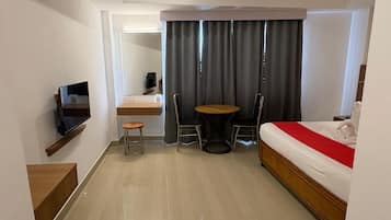 Deluxe Double Room | Living area | 32-inch LED TV with cable channels