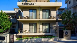 A two-story boutique hotel named Monarco with balconies, outdoor seating, and a clear view of the sky. - Monarco Executive Rooms (Rhodes)