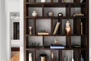 A dark wooden bookshelf with various decorative items and books. - MidMod Bungalow 5BR Heated Pool (Austin)