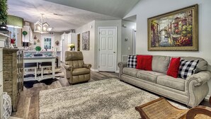 A living room with a sofa, armchair, and dining table. - Convenient to Dollywood-Dinner Shows Two Bedroom Two Bathroom- Internet Access (Pigeon Forge)