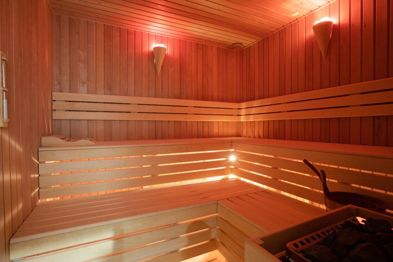 A sauna with wooden benches and infrared lights.