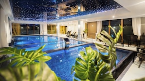 A hotel swimming pool area with two pools, lounge chairs, and potted plants. - Olivina Park domy w kompleksie Spa  (Rewal)