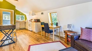 A compact living space with a kitchenette, dining area, and seating area. - Studio Loft in the Woods|Washer & Dryer|Workspace (Sequim)