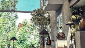 A modern building with multiple balconies, large windows, and outdoor plants. - KoenoKoeni Boutique Hotel (Parongpong)