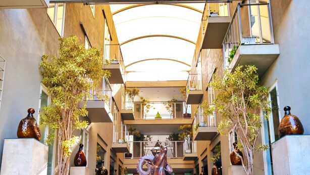A modern building with a central staircase leading to a covered area with multiple balconies. - KoenoKoeni Boutique Hotel (Parongpong)