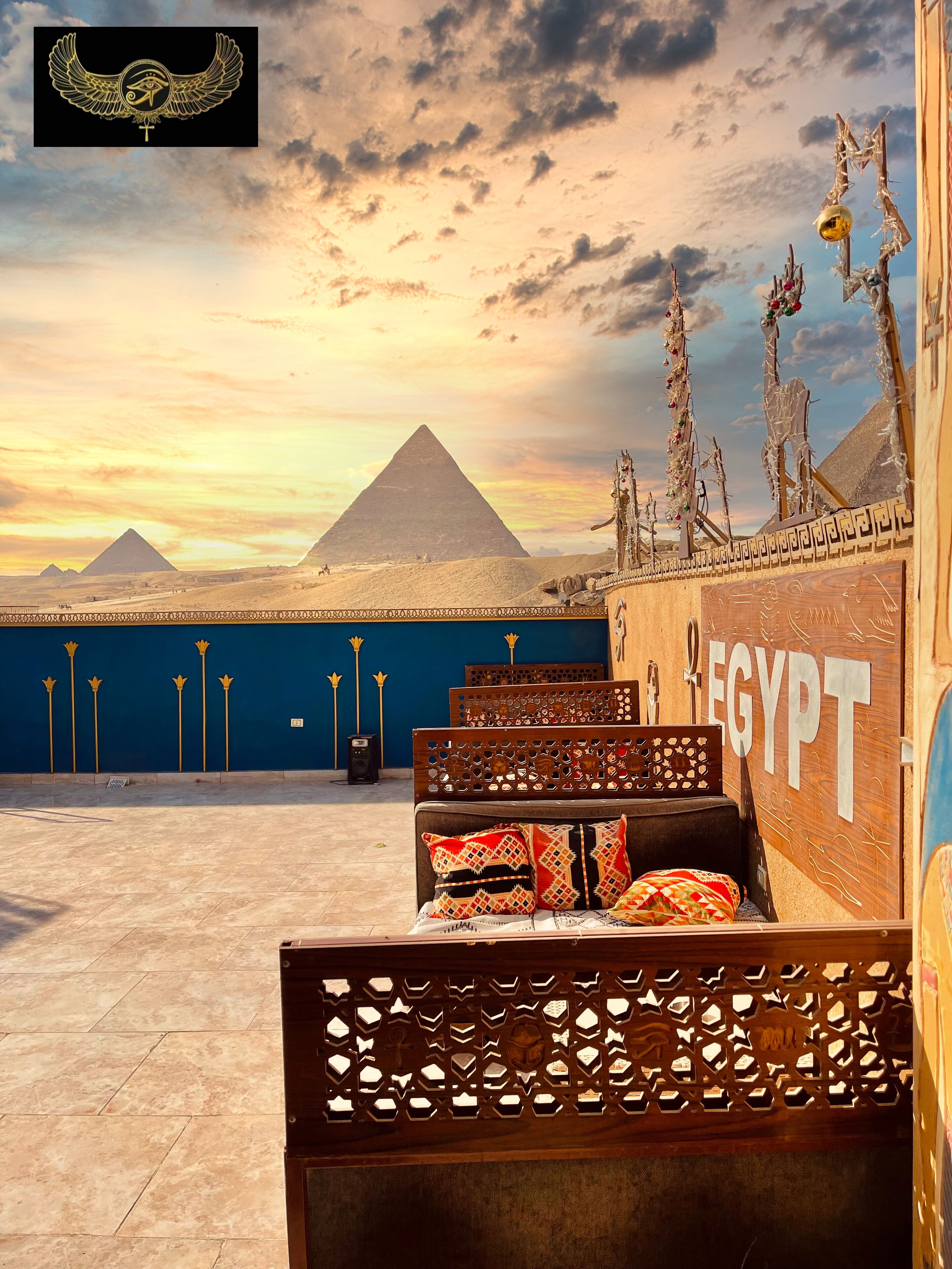 A room with a view of the pyramids, a wooden headboard, and a sign reading "EGYPT".