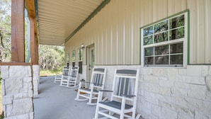 A covered porch with white rocking chairs and stone walls. - Pond + Trails On-site: Washington Escape! (Washington)