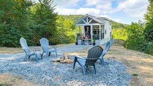 A rustic cabin with a porch, surrounded by gravel and trees. - Franklin Cottage: Deck w/ Blue Ridge Mtn Views! (Franklin)