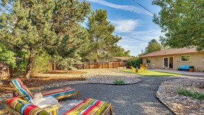 A backyard with a gravel path, lounge chairs, and a wooden deck. - Central Boulder Home w/ Outdoor Oasis, Walk to CU! (Boulder)