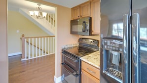 A kitchen with a stainless steel refrigerator, microwave, oven, and water dispenser. - Townhome Near Lake LBJ w/ Deck & Patio! (Horseshoe Bay)