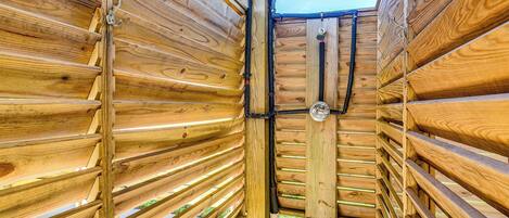 A wooden structure with horizontal slats and a central vertical support.