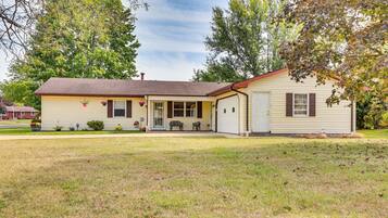 A single-story house with a front porch, a garage, and a small yard.