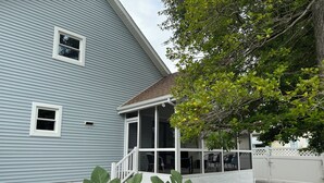 A house with a covered porch, a fenced yard, and a fig tree in the foreground. - SHORT WALK TO BEACH, QUIET RESIDENTIAL NEIGHBORHOOD (Ocean City)