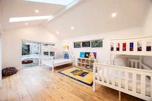 A children's playroom with bunk beds, a bookshelf, and a large window. - Galene Getaway Walk to Beach Pool Fire (Mount Martha)