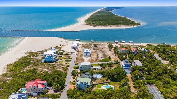 An aerial view of a coastal property with multiple buildings, a beach, and a pier. - Tranquility on beautiful St. George Island (St. George Island)
