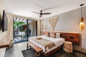 A bedroom with a bed, bedside table, bench, ceiling fan, and a view of an outdoor area with a hammock and table. - Divine 3BR PH Private Jacuzzi | Pools | SPA | Yoga (Tulum)