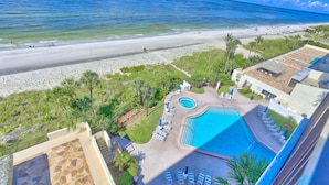 A resort with a swimming pool, beach view, and lounge area. - 🌞Beachfront🌊Ocean Sands I-808🌴Private Balcony🏖️Amazing Beach Views (Madeira Beach)