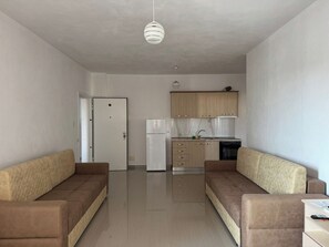 Apartment, 1 Bedroom, Balcony, City View | Living area | 40-cm flat-screen TV with cable channels